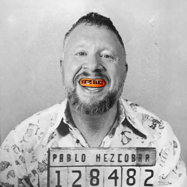 Paul Smith black and white mugshot with orange mouth guard and PABLO HEZCOBAR name board and number 128482